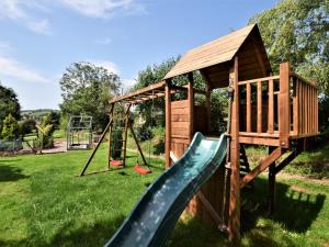 a playground with a slide and a play structure at 2 Bed in Crediton oc-51275 in Stockleigh Pomeroy