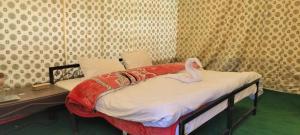 a room with a bed with a swan on it at Jispa Journey Camp Lahoul & Spiti in Manāli +36 photos