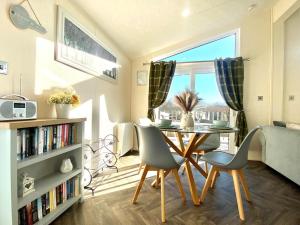 a living room with a table and chairs and a window at 2 Bed in Honiton oc-76515 in Ottery Saint Mary