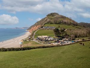 a house on a hill next to a beach at 3 Bed in Exeter oc-harri in Talaton