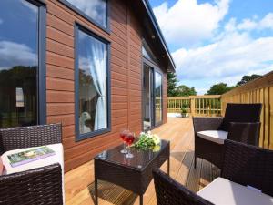 a deck with chairs and a table on a house at 2 Bed in Honiton oc-76515 in Ottery Saint Mary