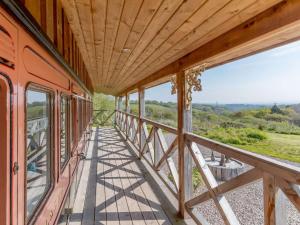 a wooden balcony with a view of the countryside at 1 Bed in Exeter oc-75423 in Longdown