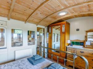 a room with a bed and a wooden ceiling at 1 Bed in Exeter oc-75423 in Longdown