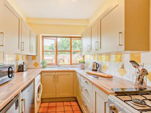 a kitchen with white cabinets and a sink at 3 Bed in Taunton oc-96235 in West Quantoxhead