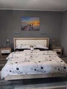 a bedroom with a bed with a white comforter at Casa Katiușa in Jurilovca