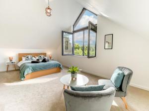a bedroom with a bed and a table and chairs at 3 Bed in Holsworthy oc-90721 in Holsworthy