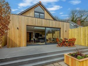a wooden deck with chairs and a table at 3 Bed in Holsworthy oc-90721 in Holsworthy