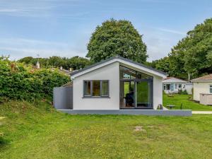 a small white house on top of a grass field at 2 Bed in Brixham oc-78565 in Brixham