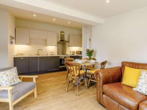 a kitchen and a living room with a couch and a table at 2 Bed in Taunton oc-83696 in Thorn Falcon