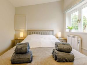 a bedroom with a bed with two ottomans at 2 Bed in Taunton oc-83696 in Thorn Falcon