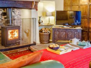 a living room with a table with a fireplace at 4 Bed in Minehead oc-90504 in Dunster