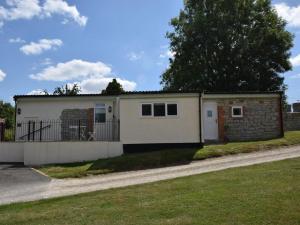 a small white house with a fence at 2 Bed in Taunton oc-83696 in Thorn Falcon +13 photos