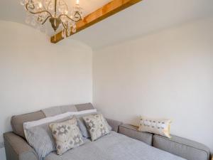 a living room with a couch and a chandelier at 1 Bed in Okehampton oc-78799 in Hatherleigh