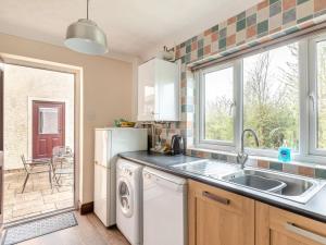 a kitchen with a sink and a dishwasher at 2 Bed in Taunton oc-41906 in Cothelstone