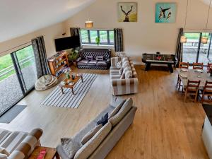 a living room with couches and a table at 5 Bed in Dulverton oc-87003 in Morebath