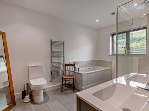 a bathroom with a tub and a toilet and a sink at 5 Bed in Dulverton oc-87003 in Morebath +23 photos