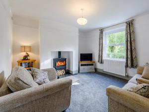 a living room with two couches and a fireplace at 5 Bed in Holsworthy oc-79454 in Milton Damerel