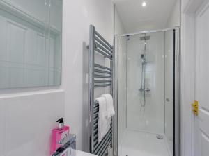 a white bathroom with a shower and a sink at 5 Bed in Holsworthy oc-79454 in Milton Damerel +24 photos