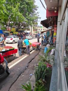 a group of people walking down a street near a market at Hotel jewel in Haridwār