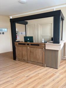 an office with a desk with a laptop on it at Hôtel L'escale des Hayons in Esclavelles