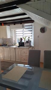 a kitchen with a counter with a microwave and a window at Apartman Mila 2 in Jajce