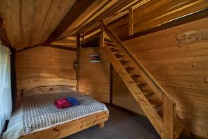 a bed in a wooden room with a staircase at Guest House Plai in Yaremche +92 photos