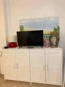 a white cabinet with a television on top of it at Arbaría vacation home in Cava D'aliga