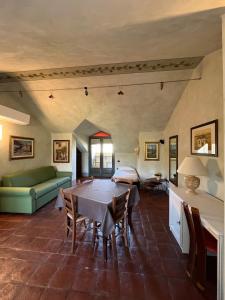 a living room with a table and a couch at Tenuta Baràc in Alba