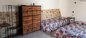 a bedroom with a bed and a chest of drawers at Chalet Gallipoli in Gallipoli