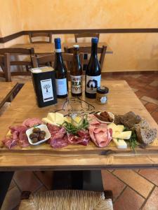 a table with bottles of wine and food on it at Locanda del Castello in Frontone