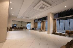 a large room with chairs and a waiting room at Hotel Pune Pride, Baner in Pune