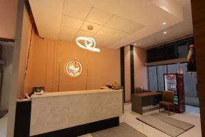a restaurant lobby with a reception desk and a sign at Hotel Pune Pride, Baner in Pune