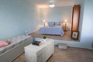 a large bedroom with a bed and a couch at Dreamy View in Folegandros in Áno Meriá