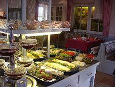 a buffet with many different types of food on display at Haus am Park in Bad Hersfeld