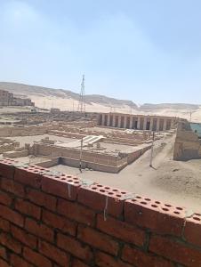 a construction site with a brick wall in the desert at فندق سيتي ابيدوس in Abydos +17 photos