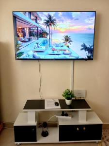 a flat screen tv hanging on a wall at Rose homes in Mombasa