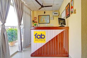 a reception area of a hotel with a ibid h hotels sign on the wall at FabHotel The Radium Inn in Rānchī