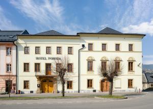 a large white building with trees in front of it at Hotel Pohoda in Staré Město +7 photos