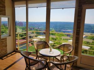 a table and chairs on a balcony with a view at Panorama Apartment in Belgrade