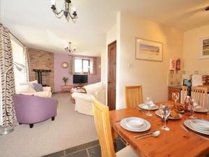 a dining room and living room with a wooden table at 2 Bed in Newton Abbot oc-61775 in Ipplepen