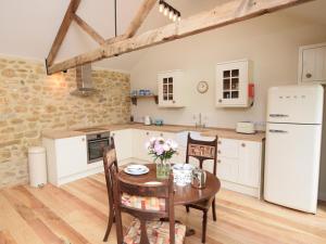 a kitchen and dining room with a table and chairs at 1 Bed in Stoke Abbott oc-50885 in Stoke Abbott