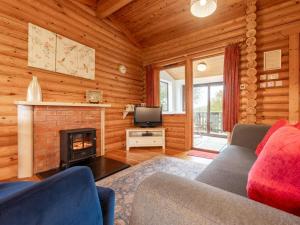 a living room with a couch and a fireplace at 2 Bed in Bideford oc-00370 in Clovelly +8 photos