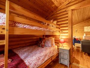a bedroom with a bed in a log cabin at 2 Bed in Bideford oc-00370 in Clovelly