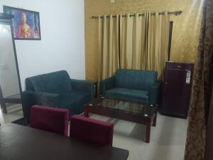 a living room with two chairs and a coffee table at Shiva House in Dehradun