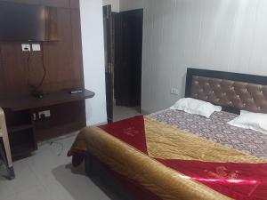 a bedroom with a bed and a dresser in it at Shiva House in Dehradun