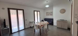 a living room with a table and a couch at il PORTICO in Tertenìa +11 photos