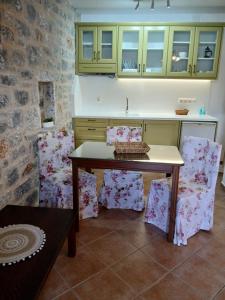 a kitchen with a table and chairs and green cabinets at Plagiaki Sea View Apartments-Mani in Neo Itilo +251 photos