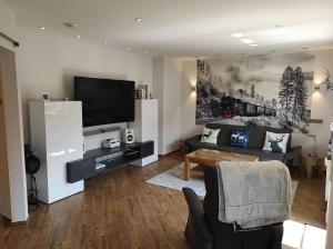 a living room with a couch and a tv at Ferienwohnung Harzoase in Bad Harzburg