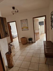 a living room with a tiled floor and a hallway at Huus 17 in Rust