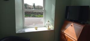 a window in a room with a table and a television at ABC Bladnoch in Newton Stewart +31 photos